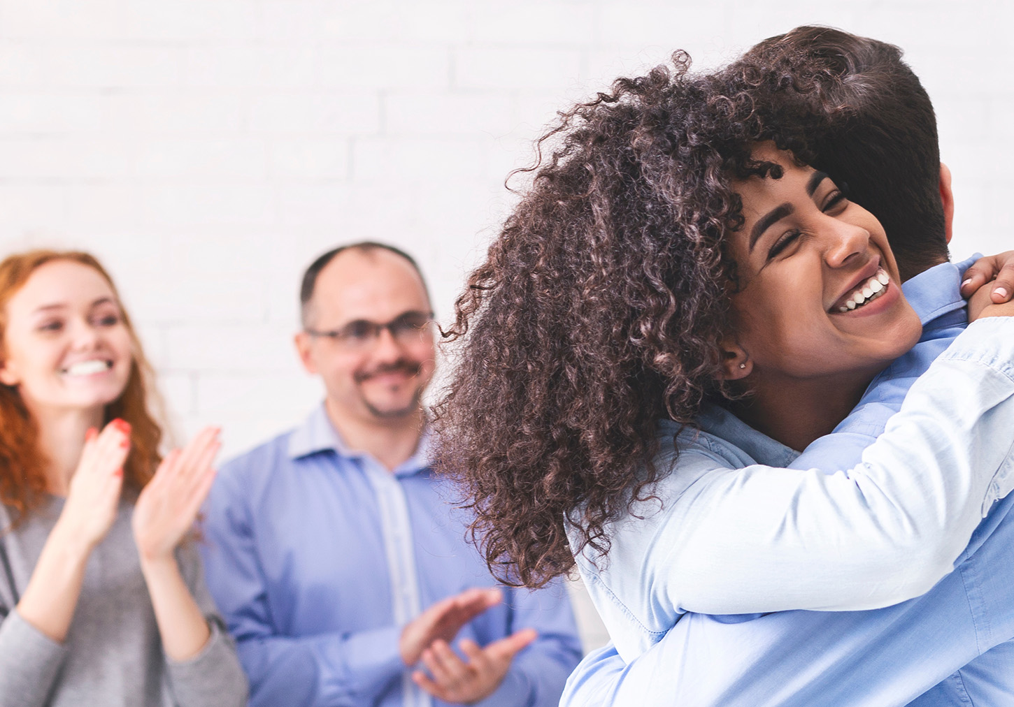 teammates hugging_building company culture-shutterstock_1629630412